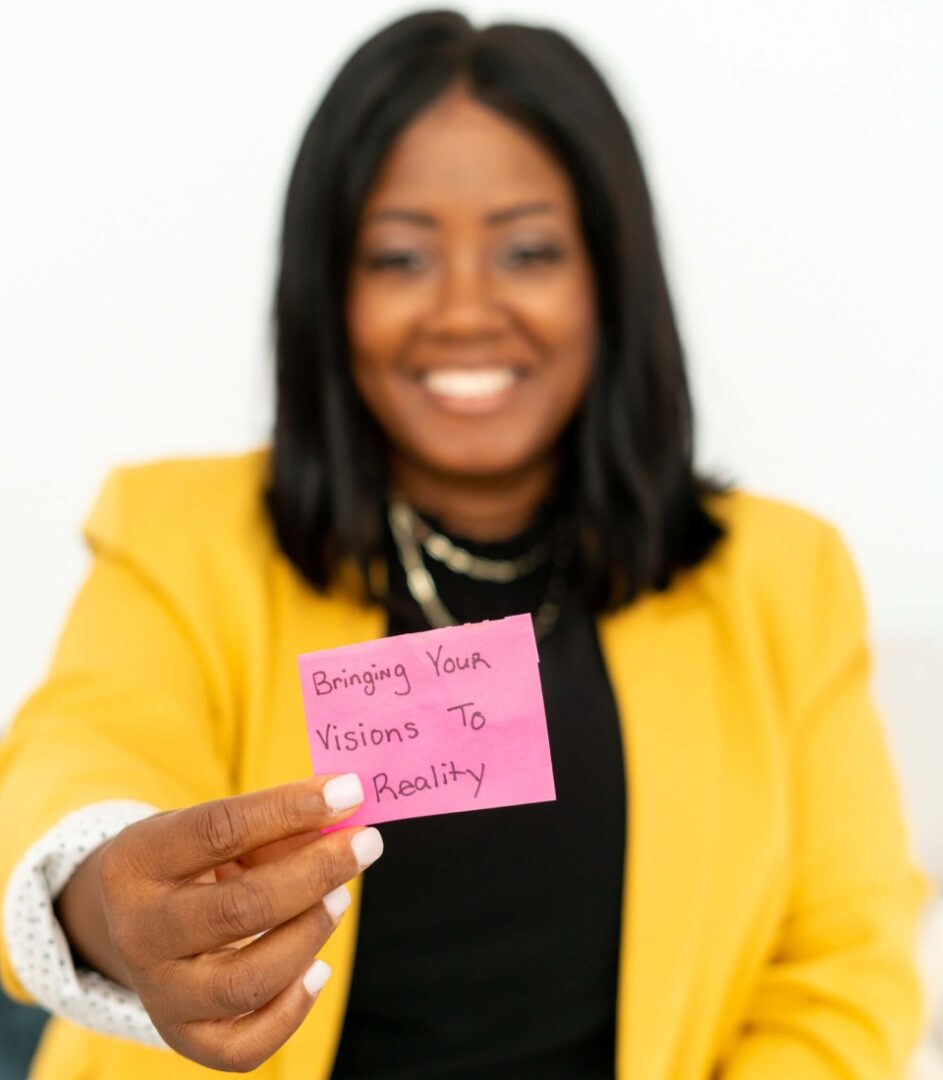 A woman holding up a pink note with the words " sincerely yours."