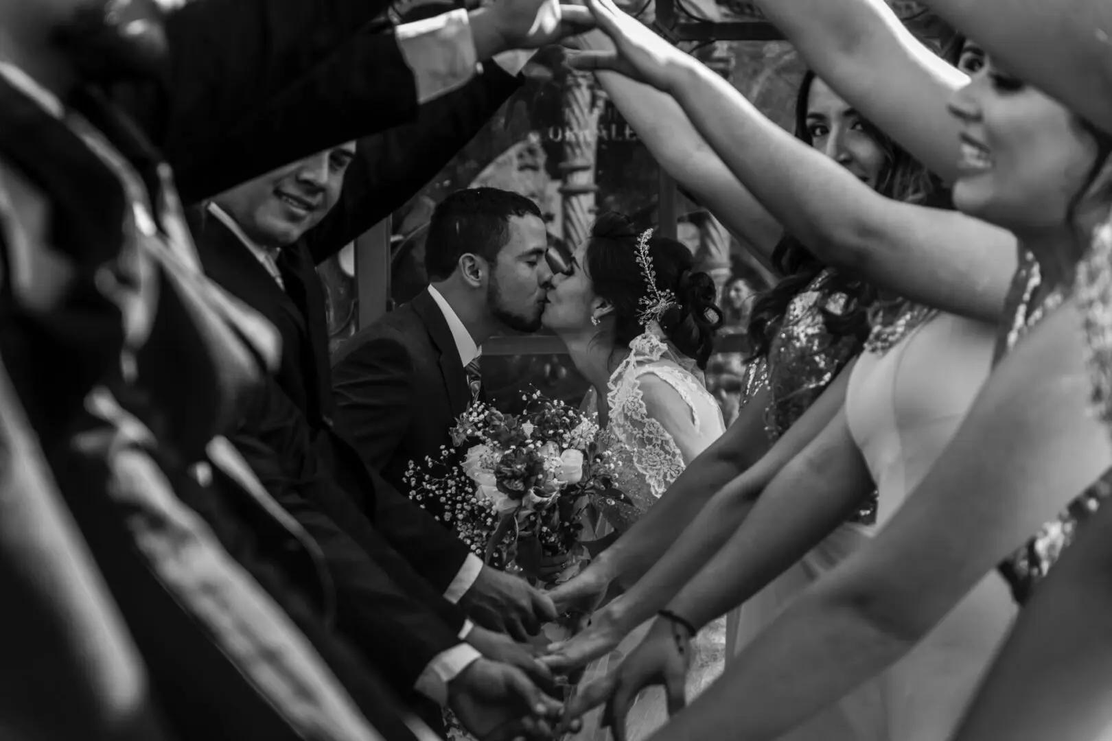 A black and white photo of two people kissing